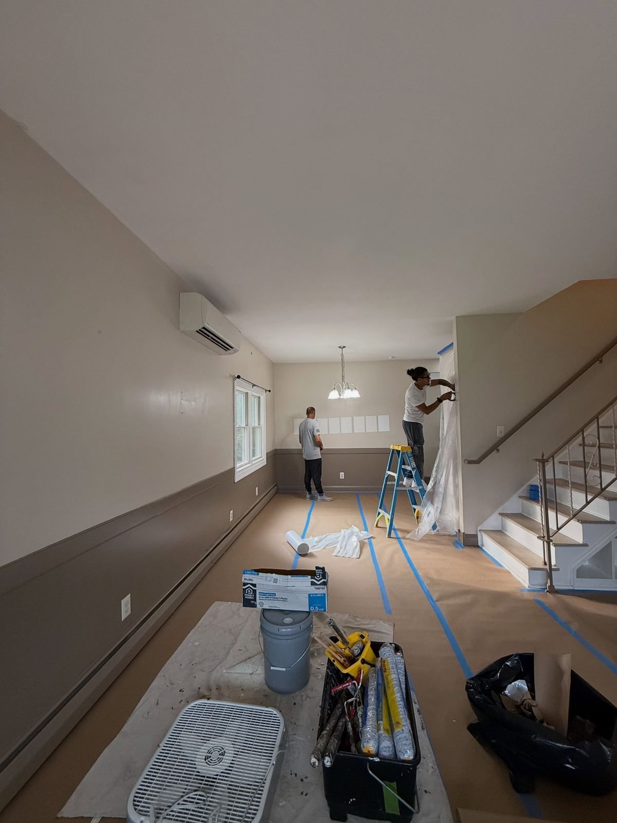 Living room being painted, floors covered — Catanzaro's Power Washing