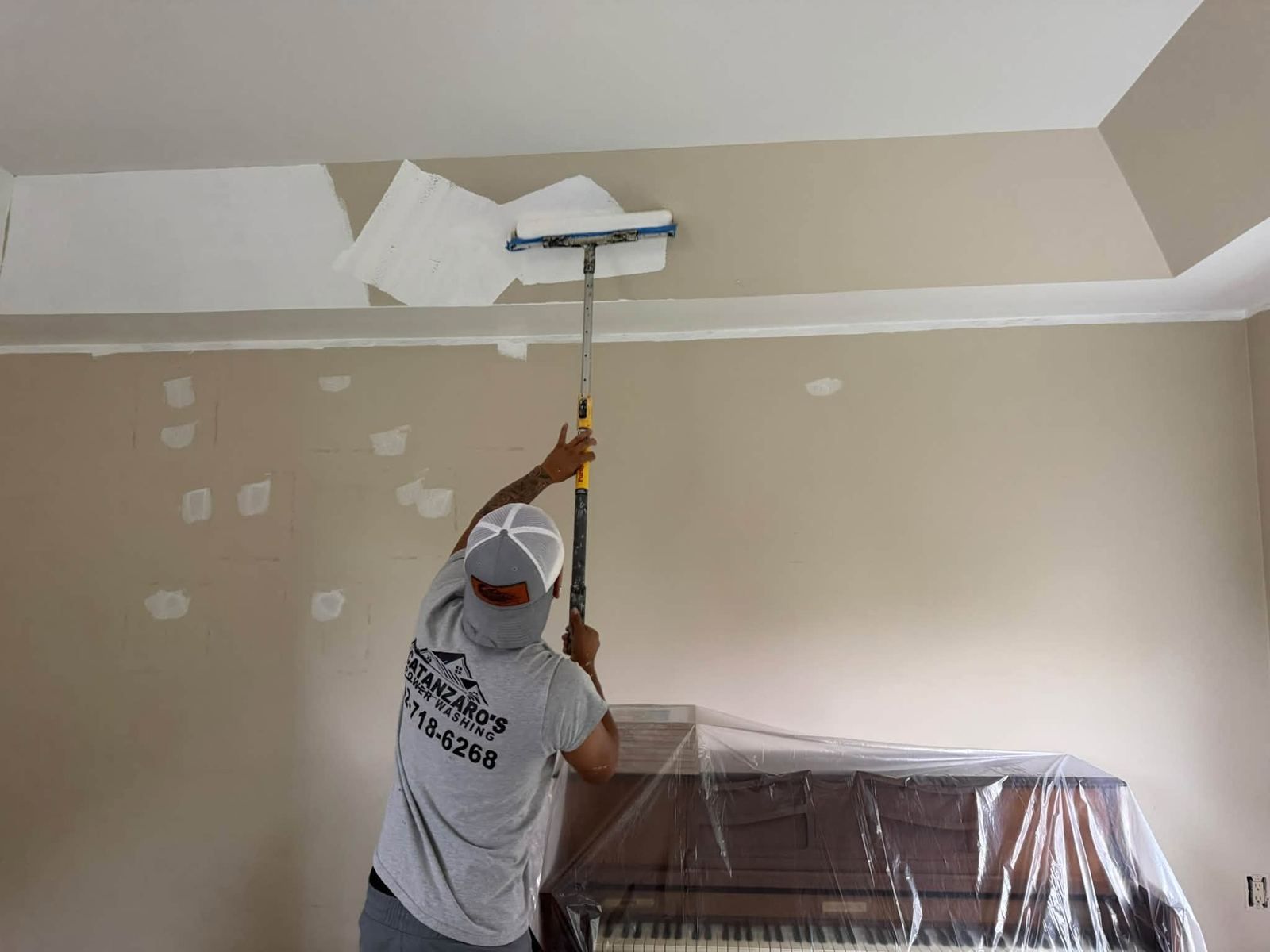 Painter rolling ceiling white — Catanzaro's Power Washing
