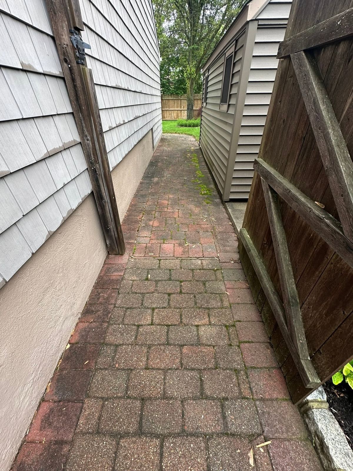 Narrow brick side path between house and fence — Catanzaro's Power Washing