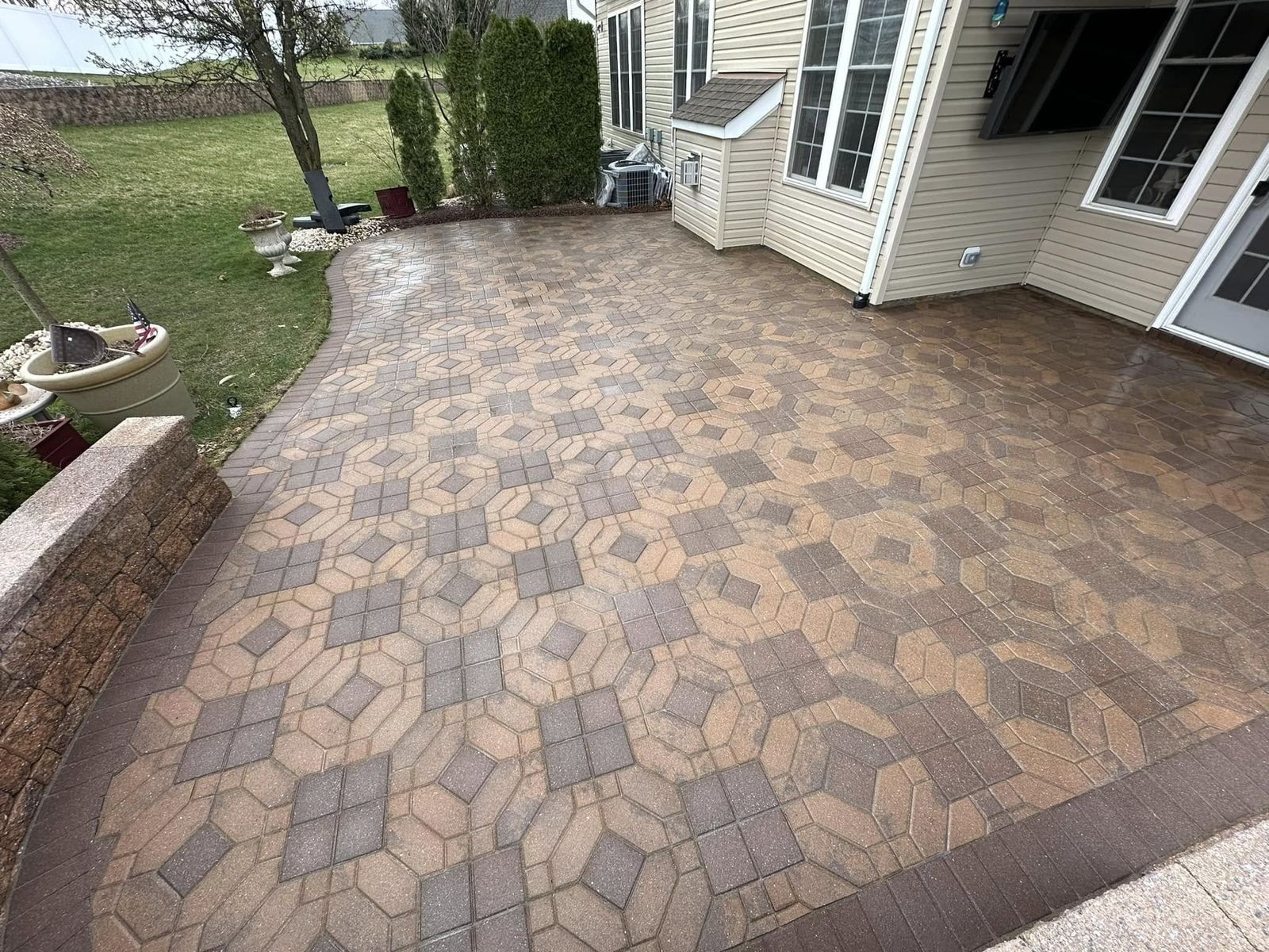 Paver patio beside house, cleaned — Catanzaro's Power Washing
