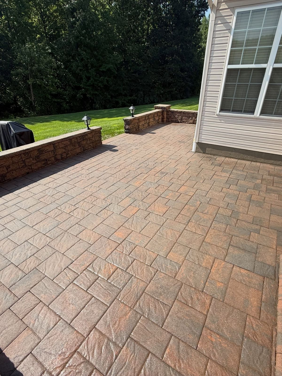 Paver patio by house, cleaned — Catanzaro's Power Washing