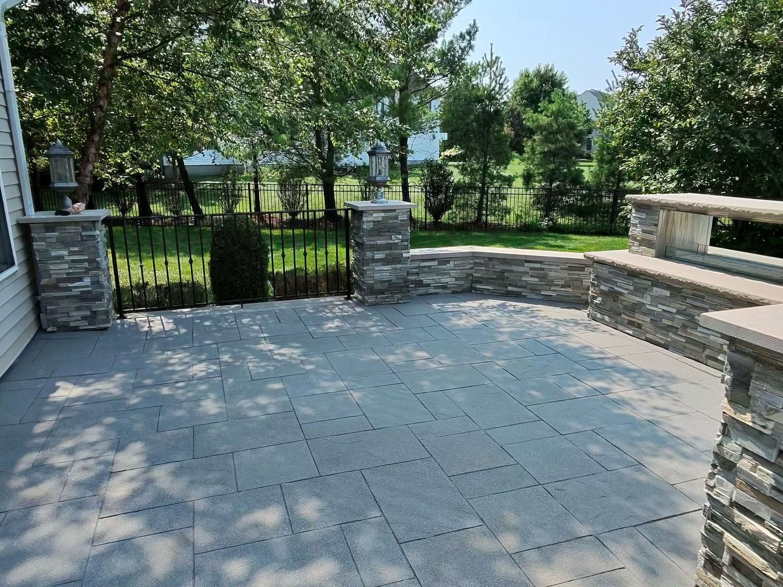 Paver patio with stone walls, cleaned — Catanzaro's Power Washing