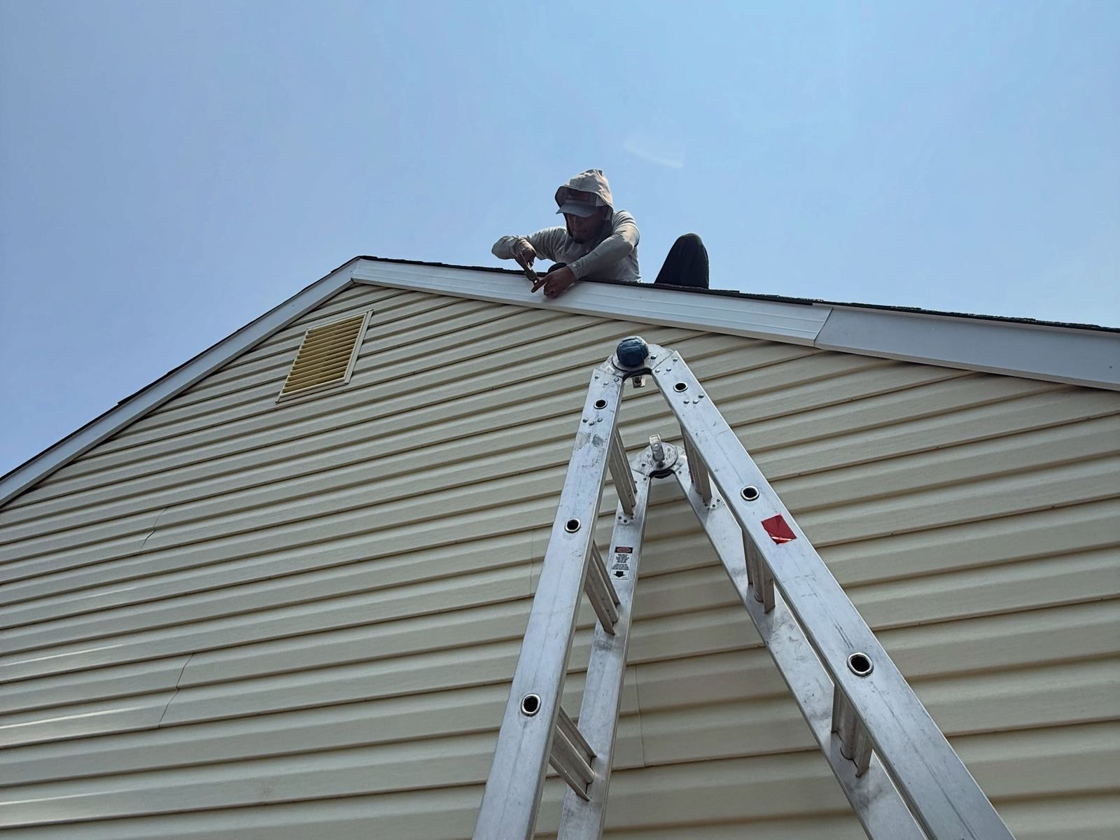 Crew on roof peak with ladder — Catanzaro's Power Washing