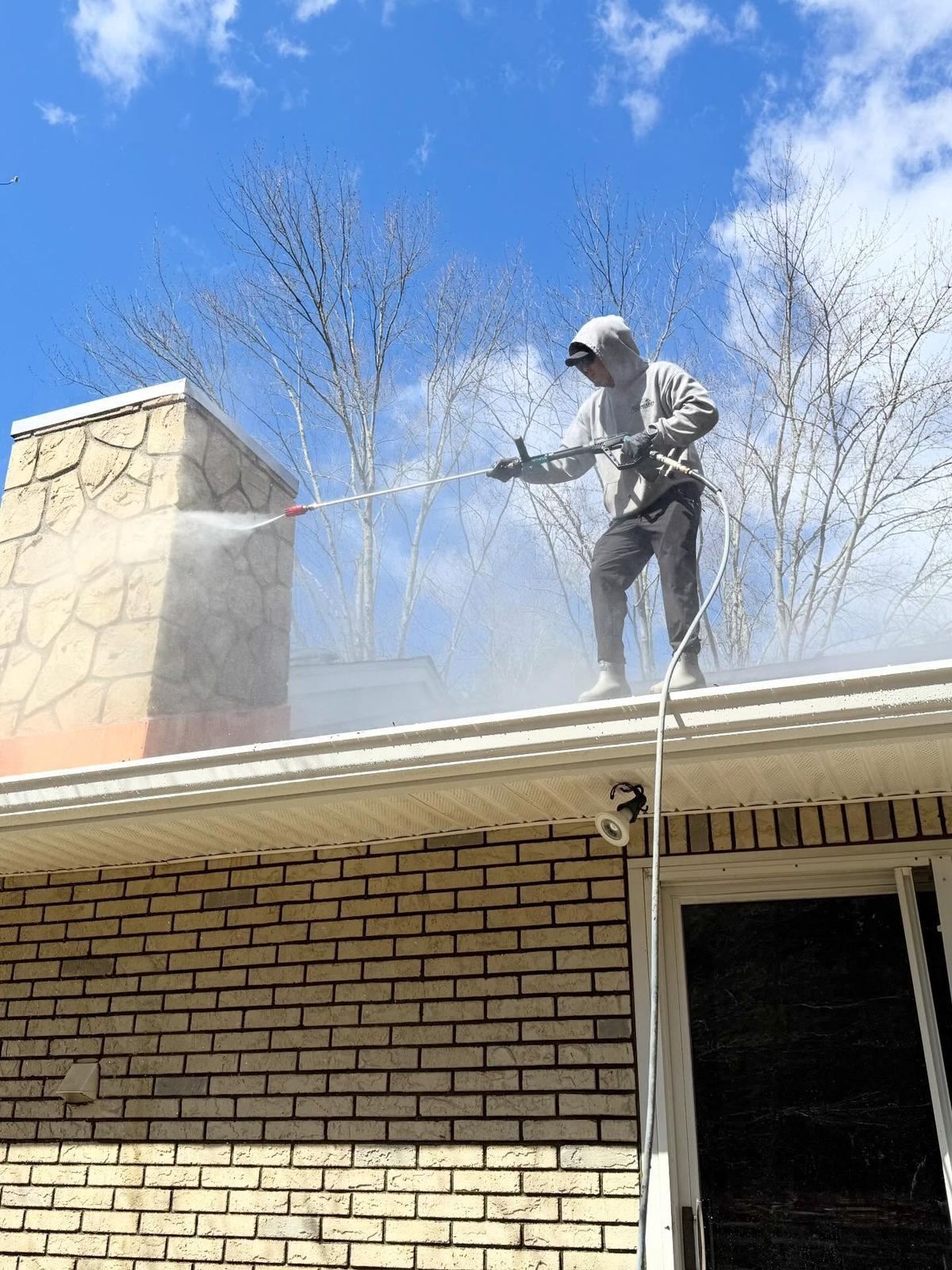 Crew washing roof above chimney — Catanzaro's Power Washing