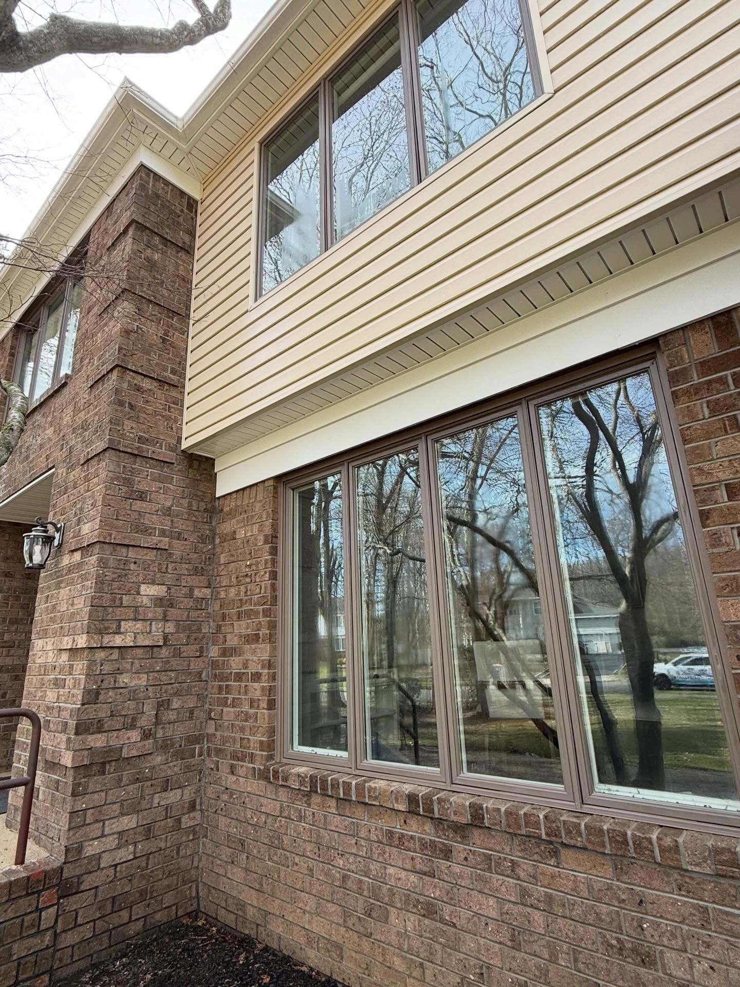 Brick wall with large windows, cleaned — Catanzaro's Power Washing