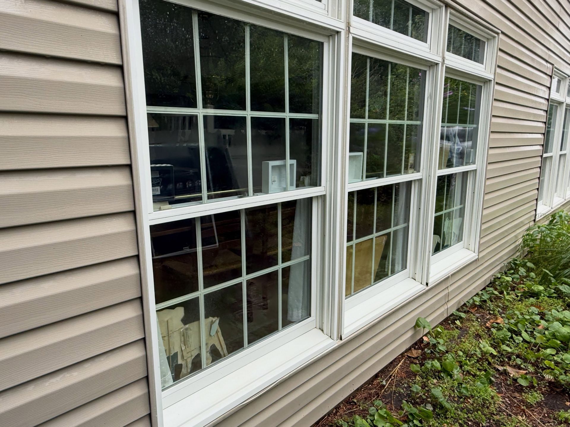 Large windows on tan siding, cleaned — Catanzaro's Power Washing