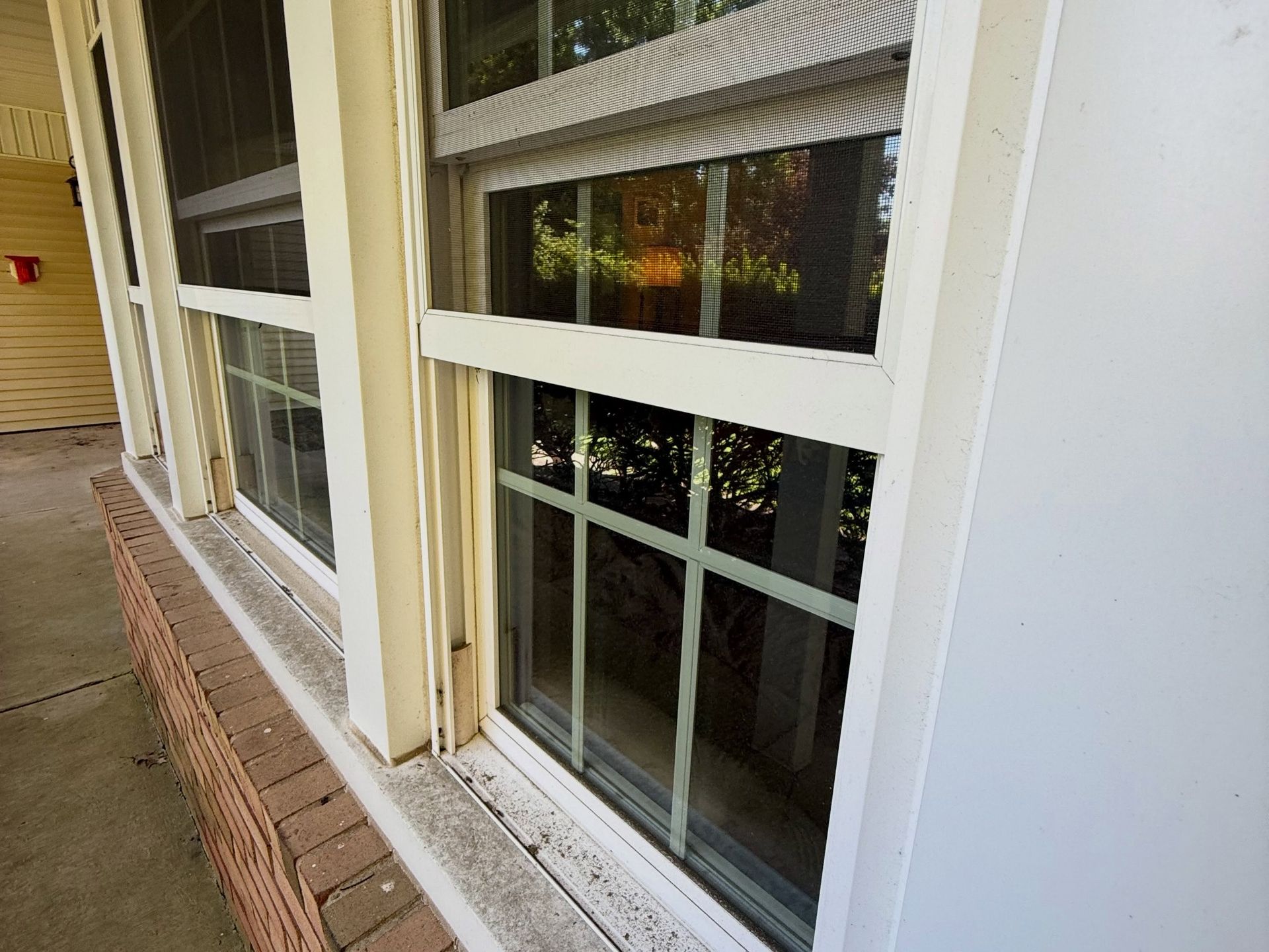 Window glass by brick walk, cleaned — Catanzaro's Power Washing