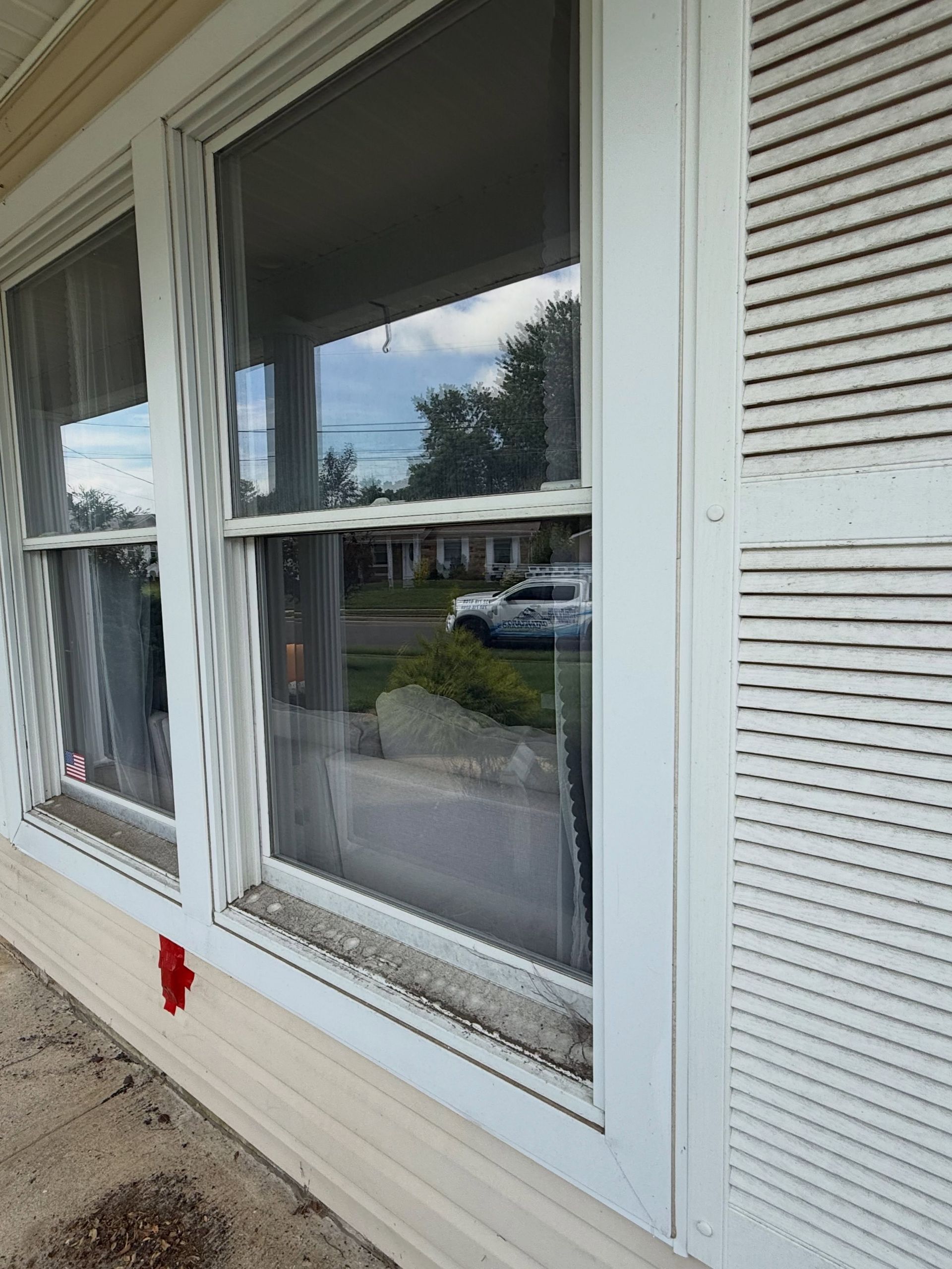 Window with white shutters, cleaned — Catanzaro's Power Washing