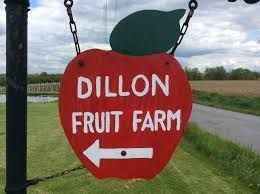 Red apple-shaped sign with white text,