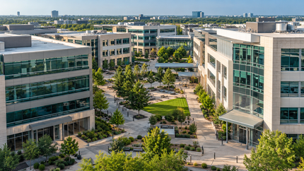 Multi-tenant commercial office complex with landscaped common areas.
