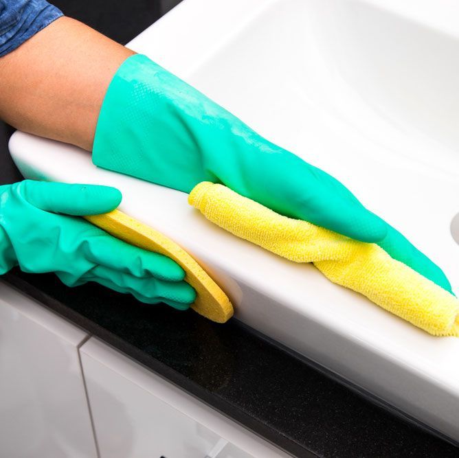 Wiping the Bathroom Sink with Precision and Care - Comprehensive Cleaning Services in Ballina