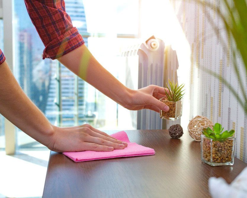 Worker Cleaning an Office Desk - Comprehensive Cleaning Services in Ballina