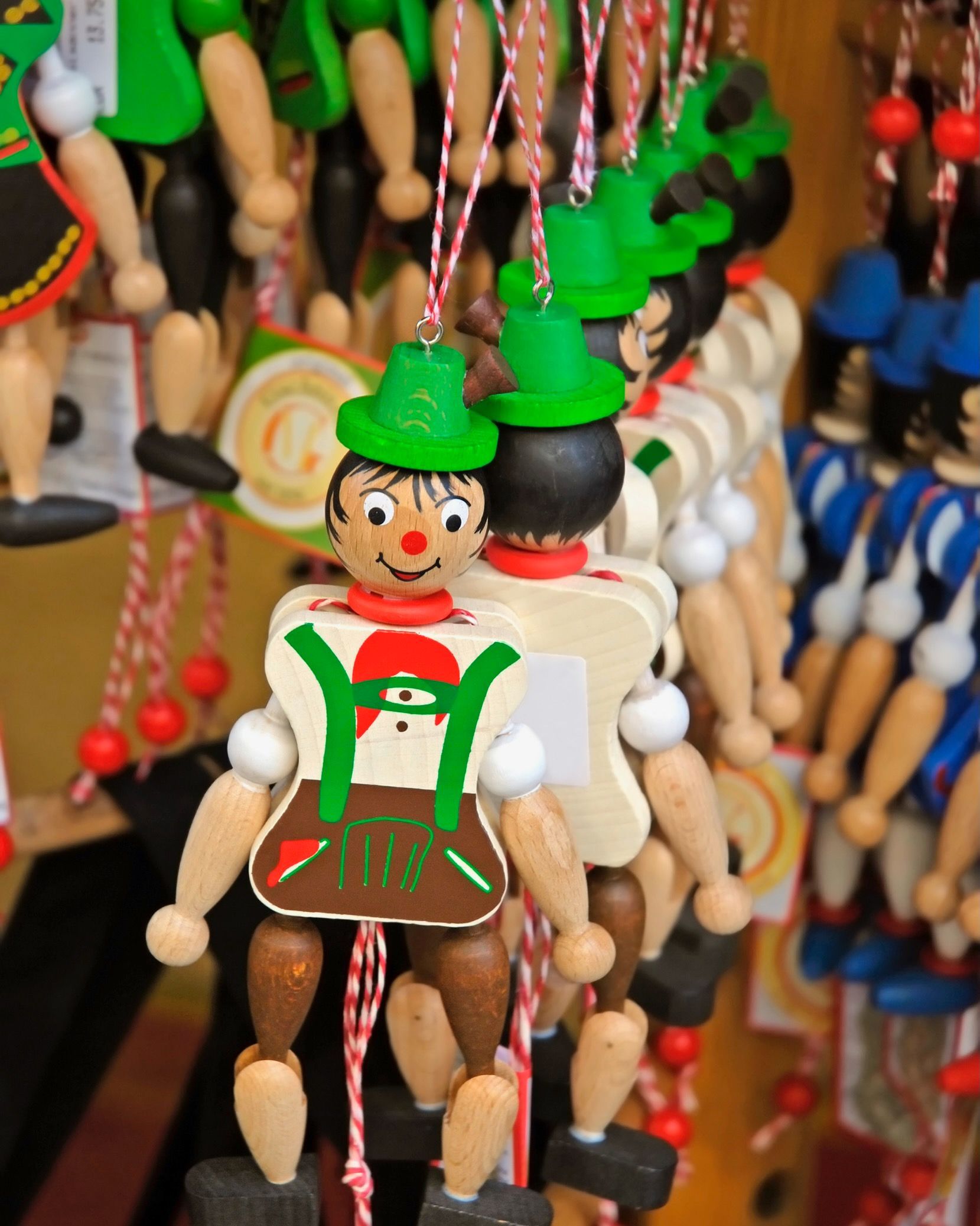 A bunch of wooden dolls are hanging from a string