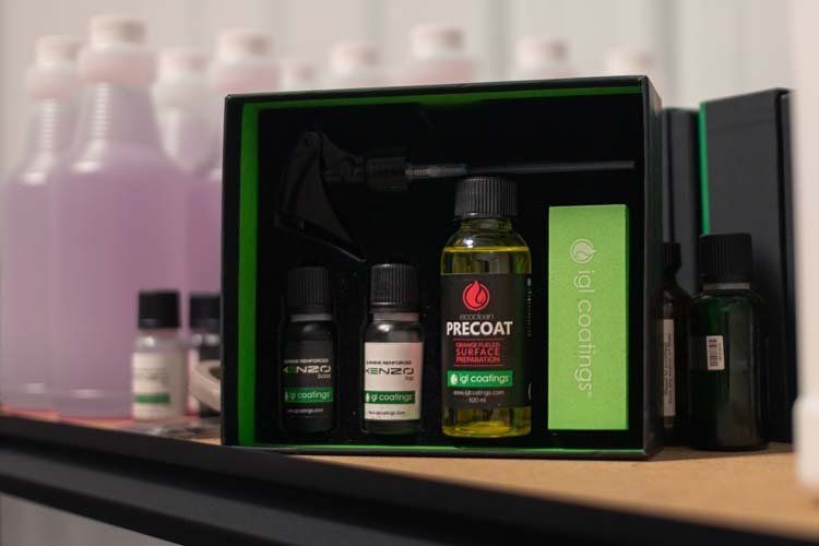 A box of bottles sitting on top of a wooden table.