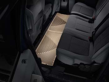 The back seat of a van with a light on the floor.
