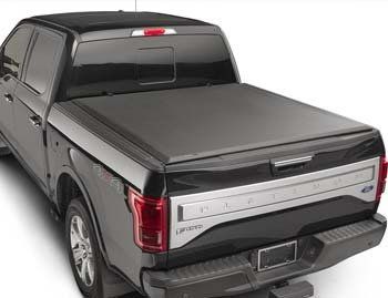 A black truck with a black bed cover on it.