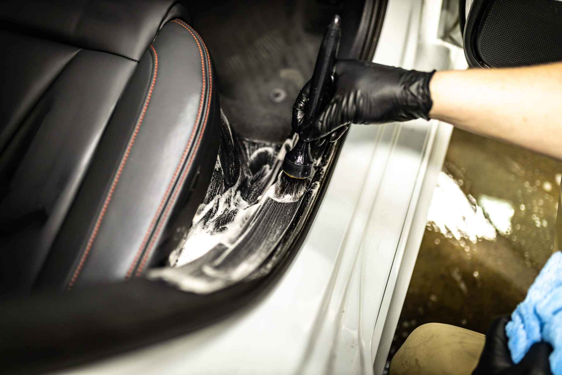 A person is cleaning the interior of a car.