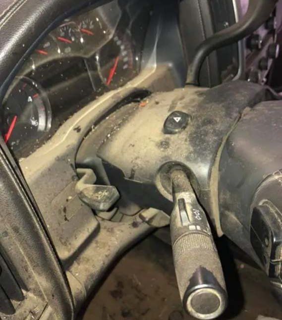 A dirty steering wheel and dashboard of a car