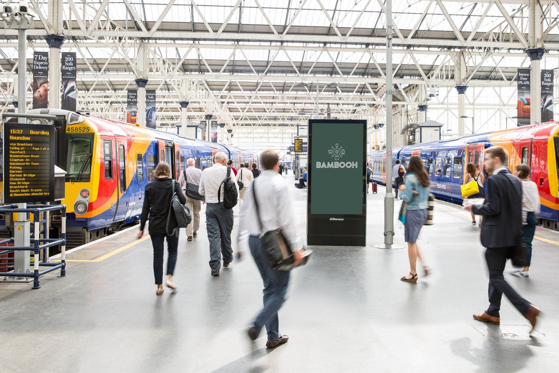 A group of people are walking around a train station.