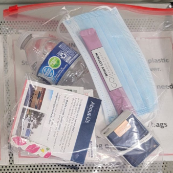 Clear zip bag of assorted personal care items, including a blue mask, lotion, and packaged supplies Clear zip bag of assorted personal care items, including a blue mask, lotion, and packaged supplies
