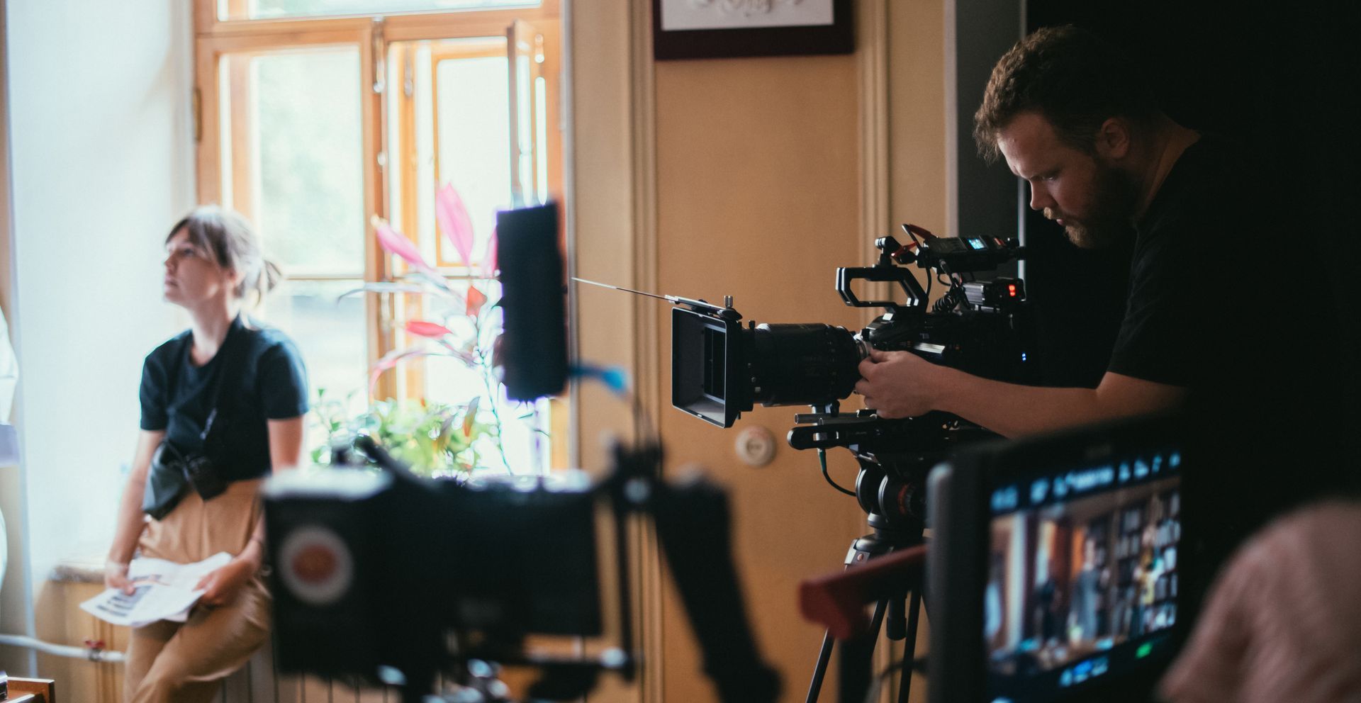A person operates a film camera.