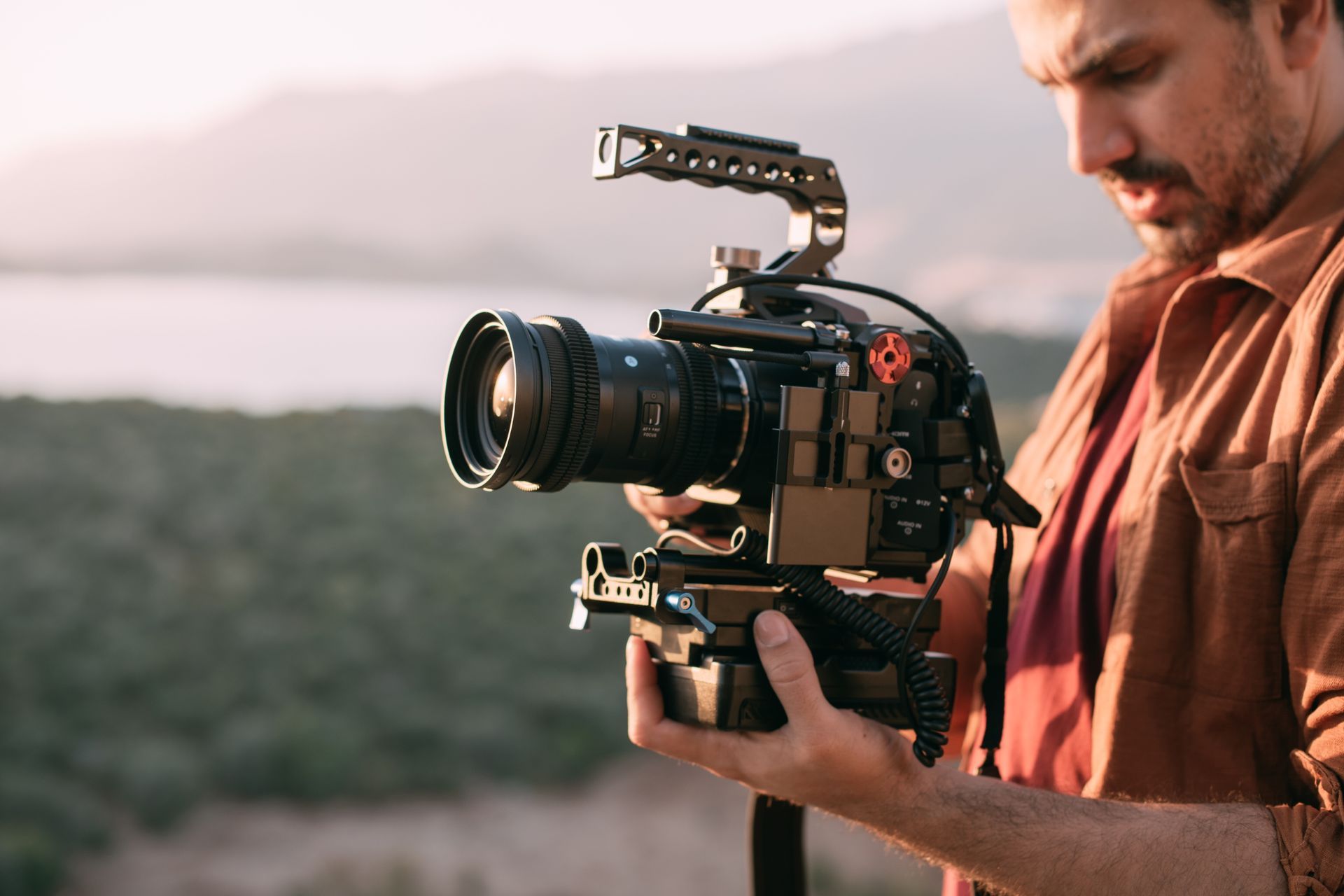 Man holding a professional video camera.