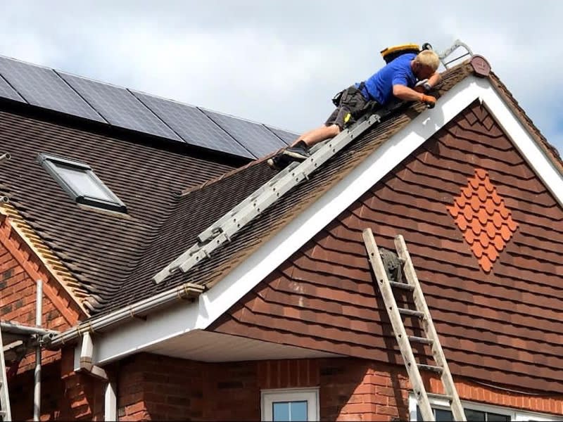 roofer atop roof