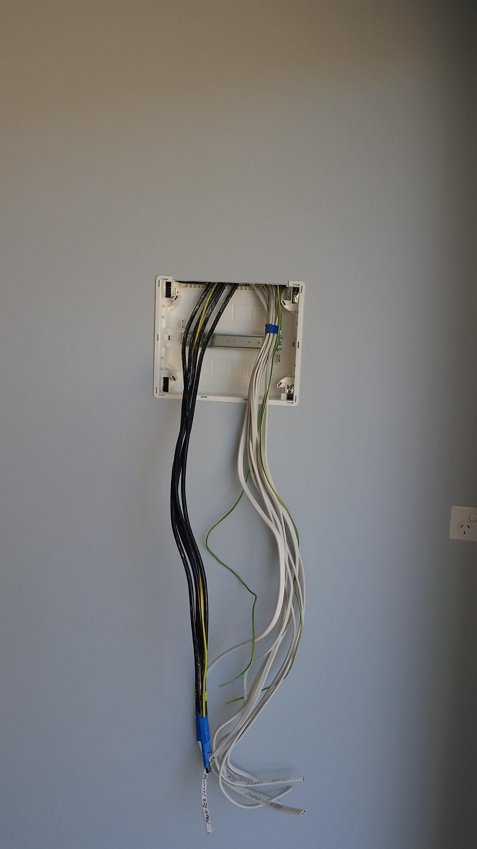 A Bunch of Wires Are Hanging out Of a Box on A Wall — All Star Electrical Services in Wollongong, NSW