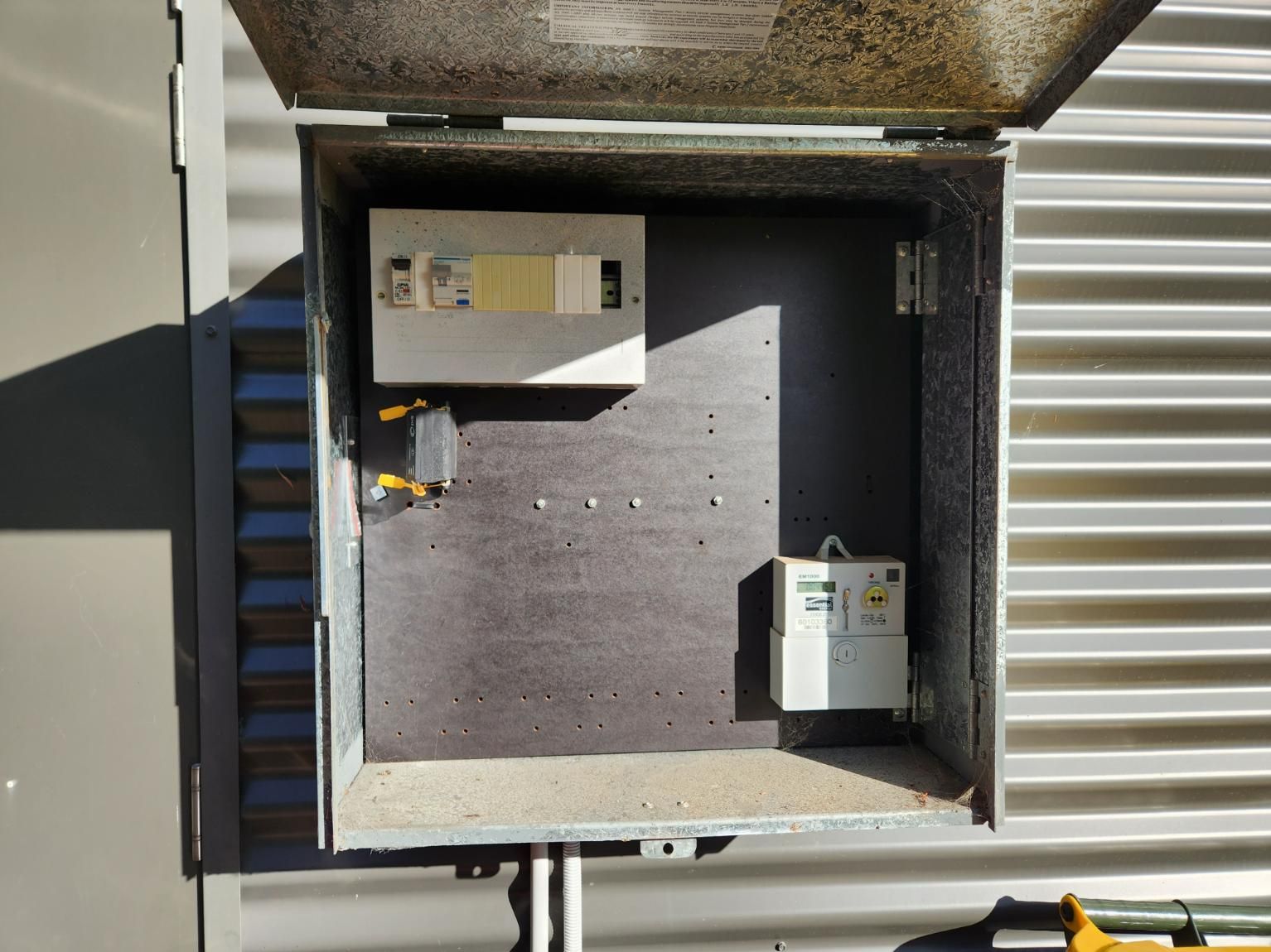 An Electrical Box Is Sitting on The Side of A Building — All Star Electrical Services in Horsley, NSW