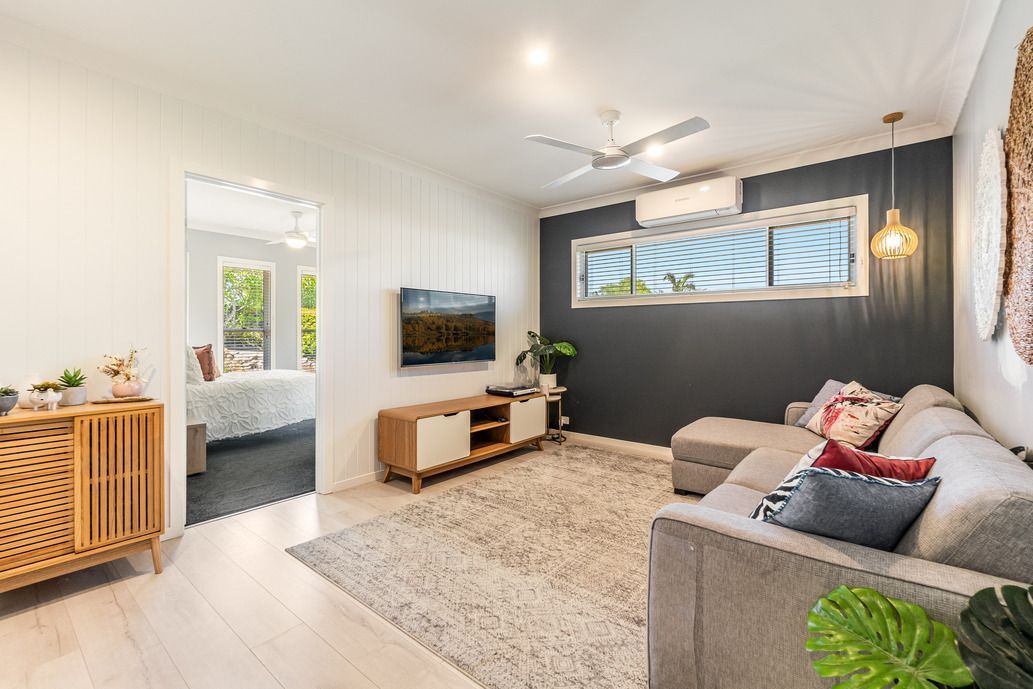 A Ceiling Fan Is Hanging from The Ceiling of A Room Next to A Window — All Star Electrical Services in Wollongong, NSW