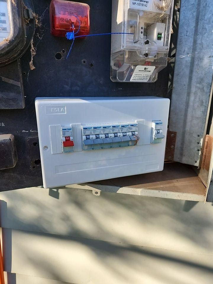 A White Electrical Box Is Sitting on Top of A Wooden Table — All Star Electrical Services in Horsley, NSW