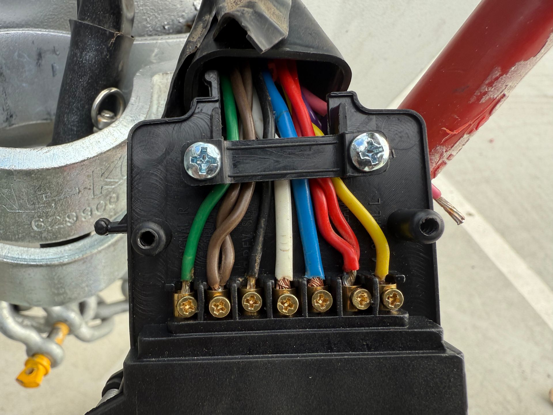 Trailer wiring connector with colored wires attached to terminals.
