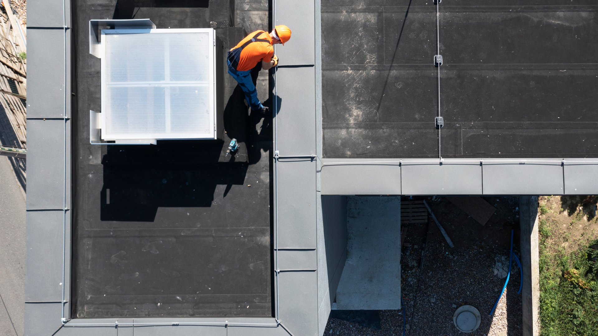 An aerial view of a man working on a roof.