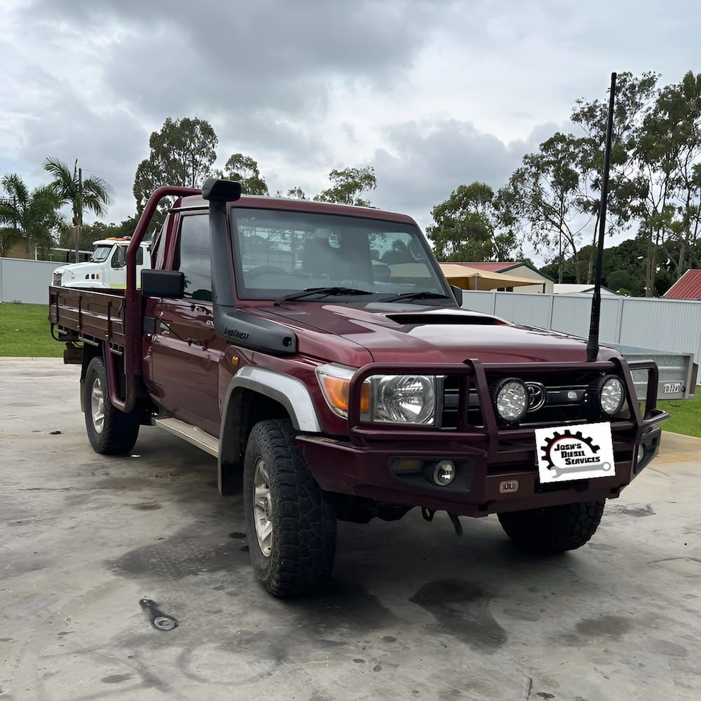 A Red Truck Is Parked In A Parking Lot — Josh's Diesel Services in Bororen, QLD