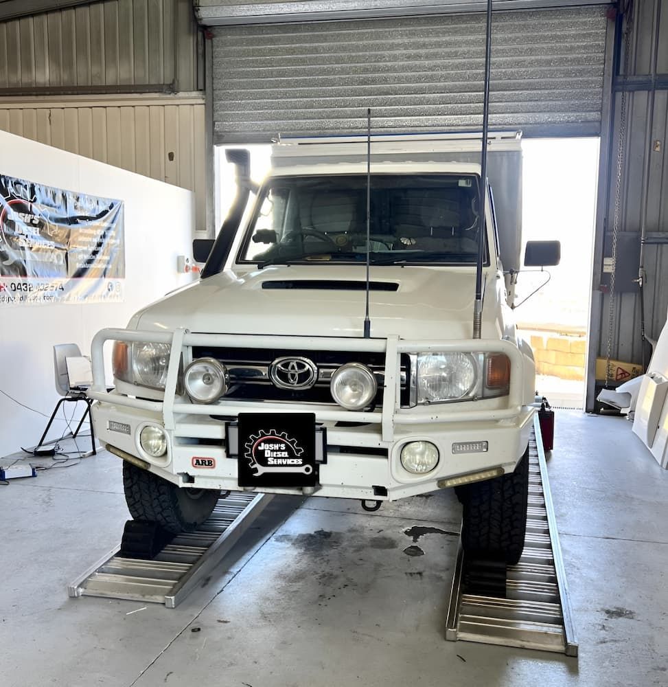 A White Toyota Truck Is Parked In A Garage — Josh's Diesel Services in Tannum Sands, QLD