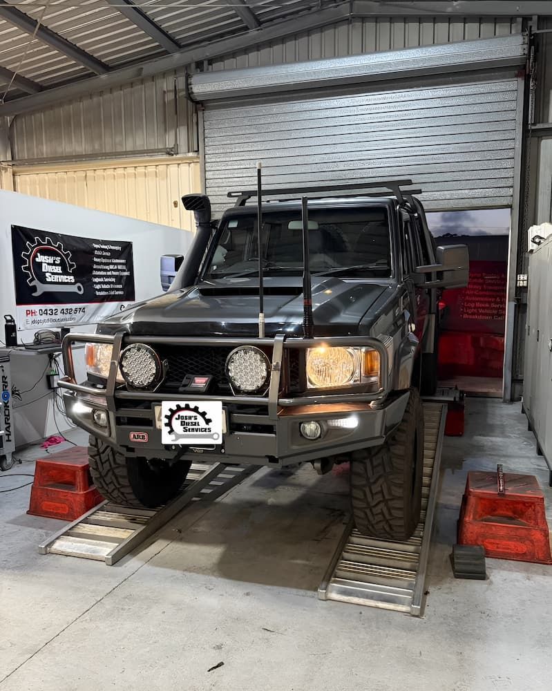 A Truck Is Parked On A Ramp In A Garage — Josh's Diesel Services in Boyne Island, QLD