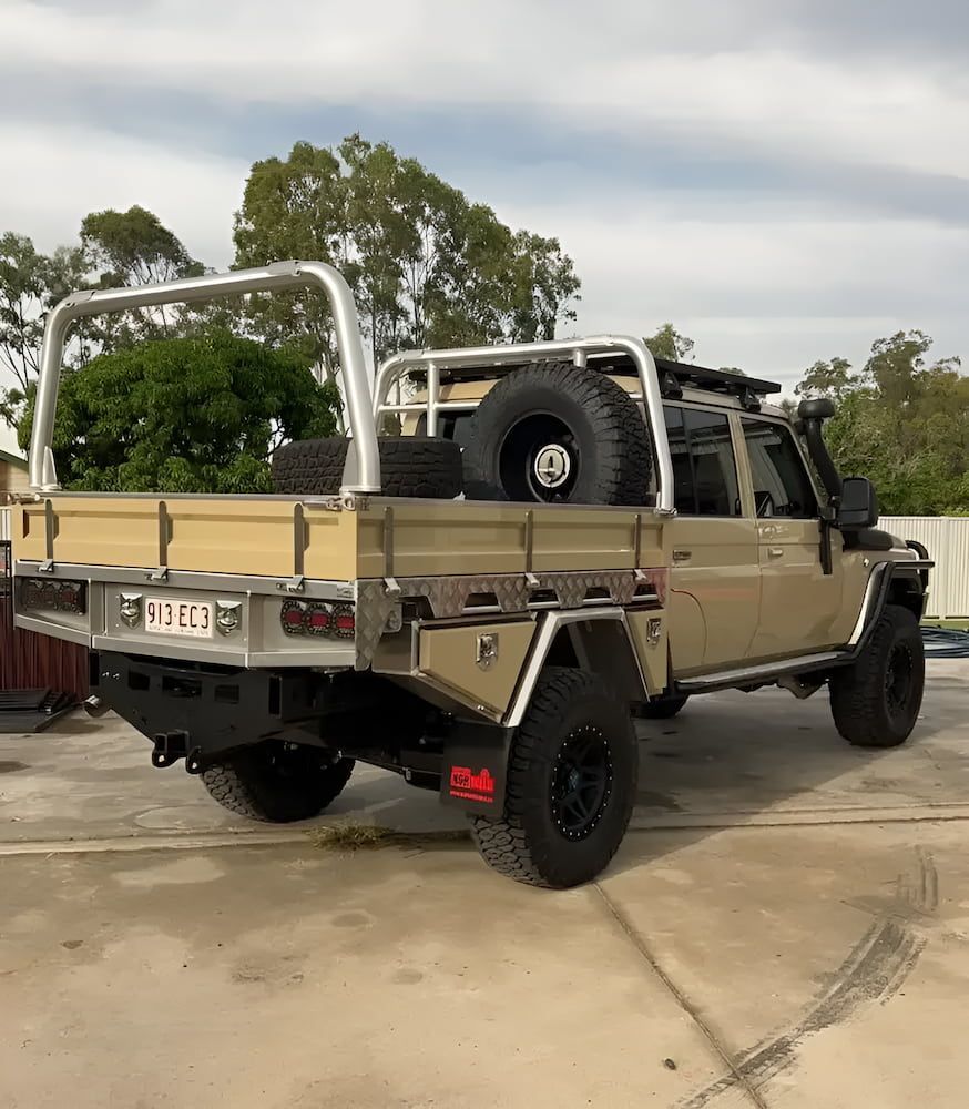 A Truck With A Tray On The Back Is Parked In A Parking Lot — Josh's Diesel Services in Boyne Island, QLD