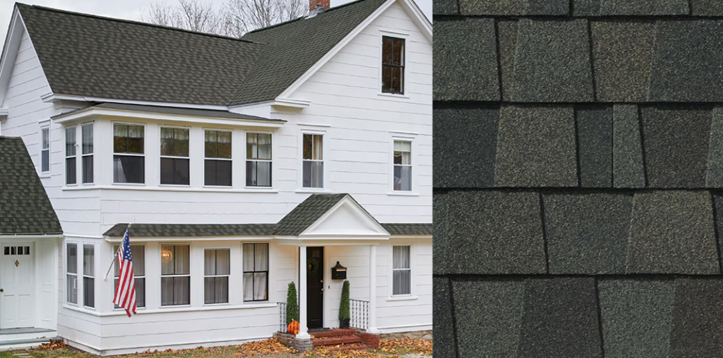 White two-story house with American flag, front porch, and dark shingle roof close-up on the right