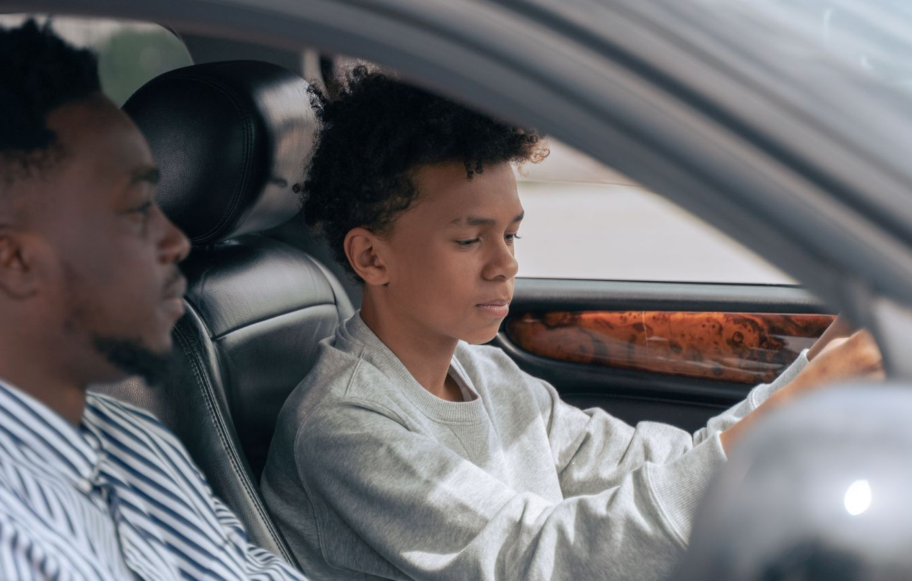 Teen Driver Behind the Wheel of Sedan