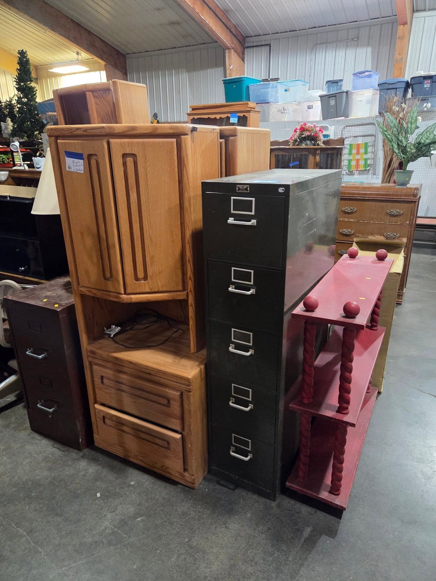 Stacked wooden and metal office cabinets and drawers in a storage area