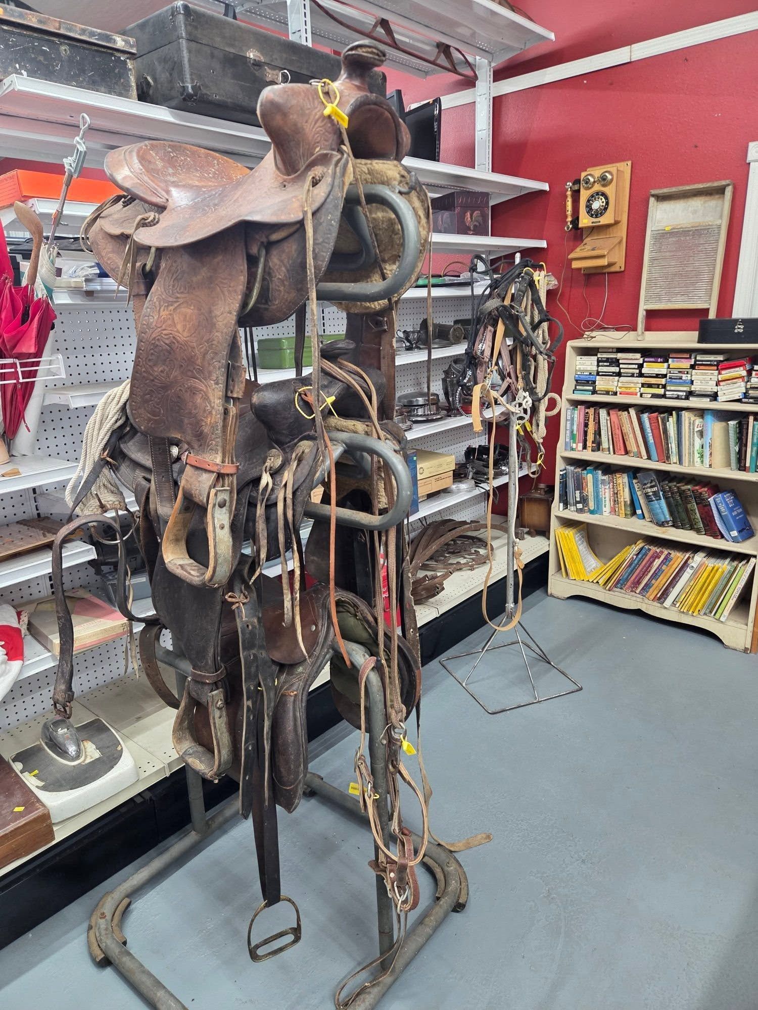 Metal sculpture of a saddled horse in a library, surrounded by shelves and tools