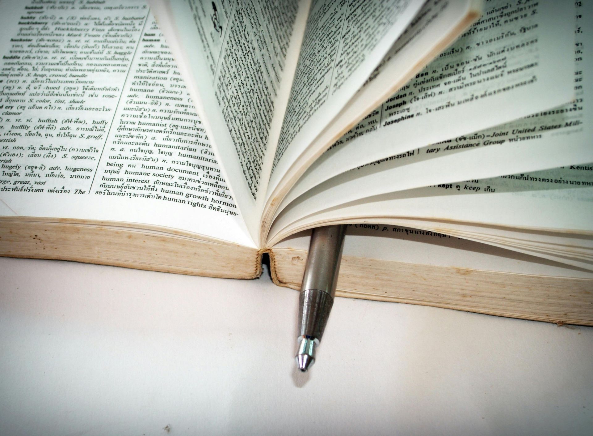 Open book with pen marking a page.