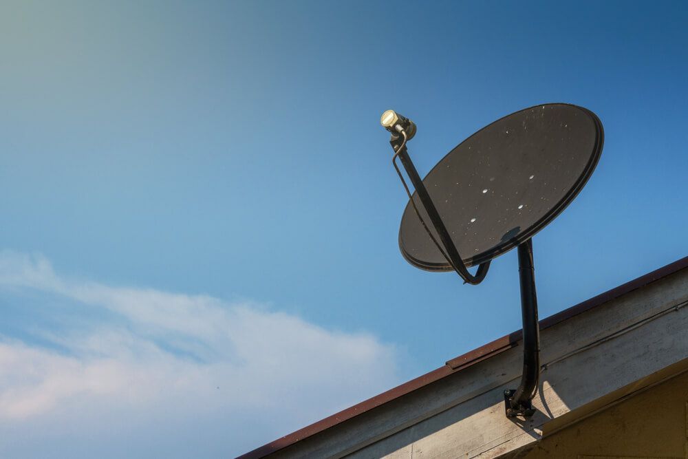 A Satellite Dish Is Mounted on The Roof of A Building — BTV Antenna & Data in Bundaberg, QLD