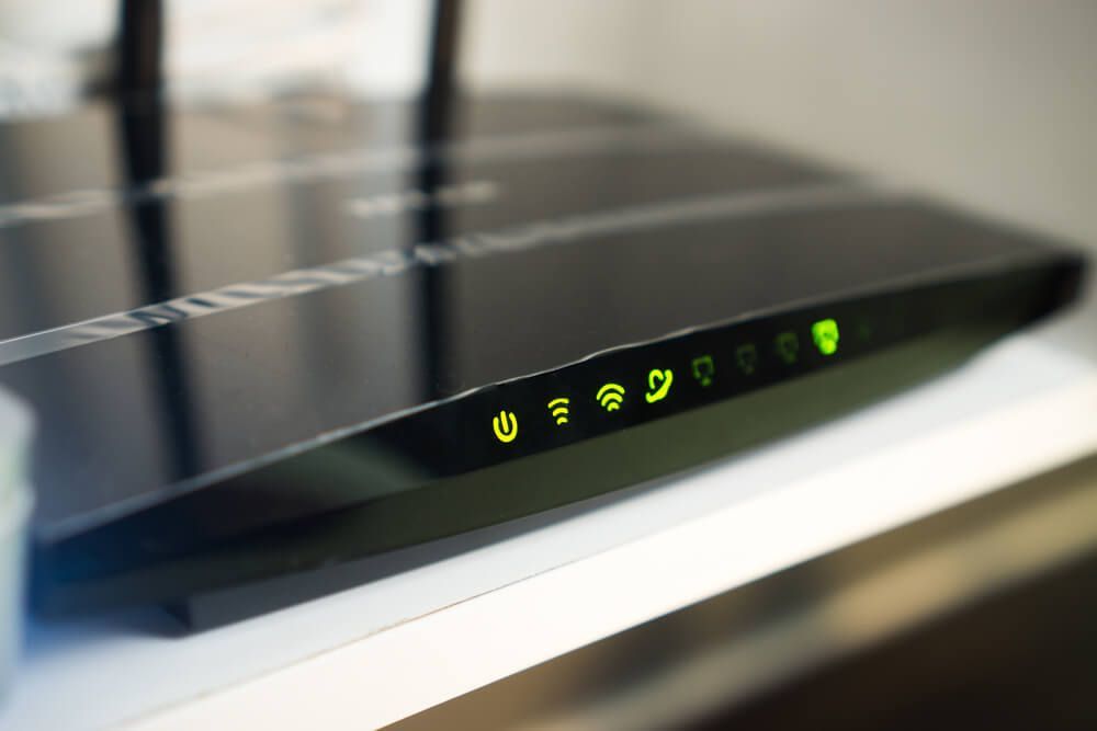 A Black Router Is Sitting on Top of A White Table — BTV Antenna & Data in Coral Cove, QLD