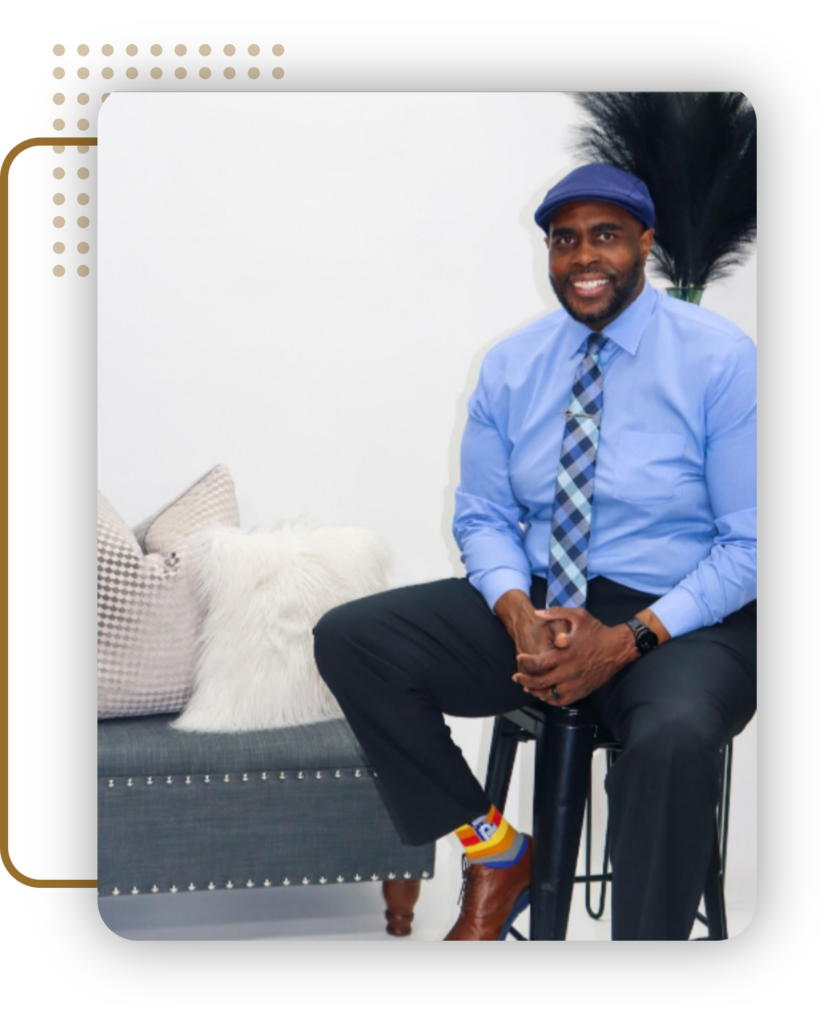 a man in a blue shirt and tie is sitting on a stool