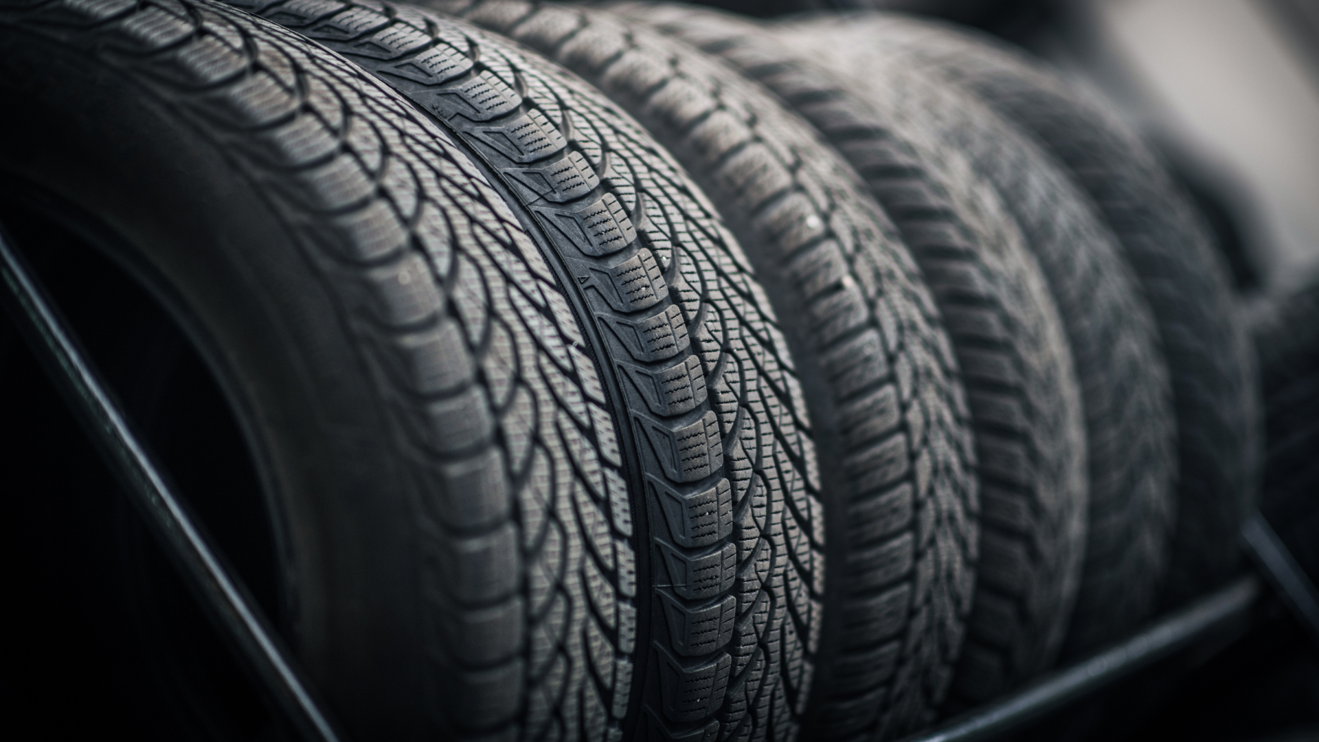 Tires stacked in a row, showcasing their tread pattern.