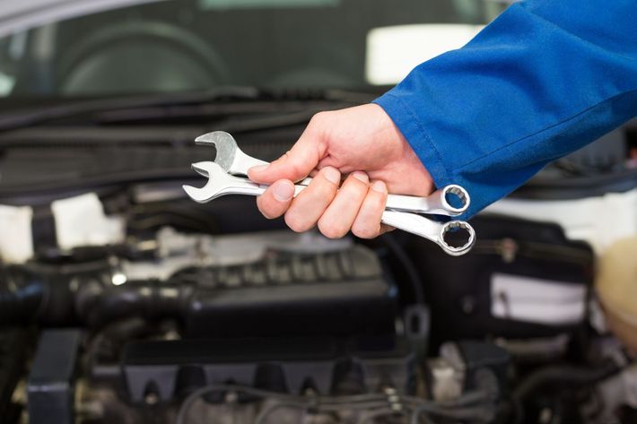 Technician holding two wrenches