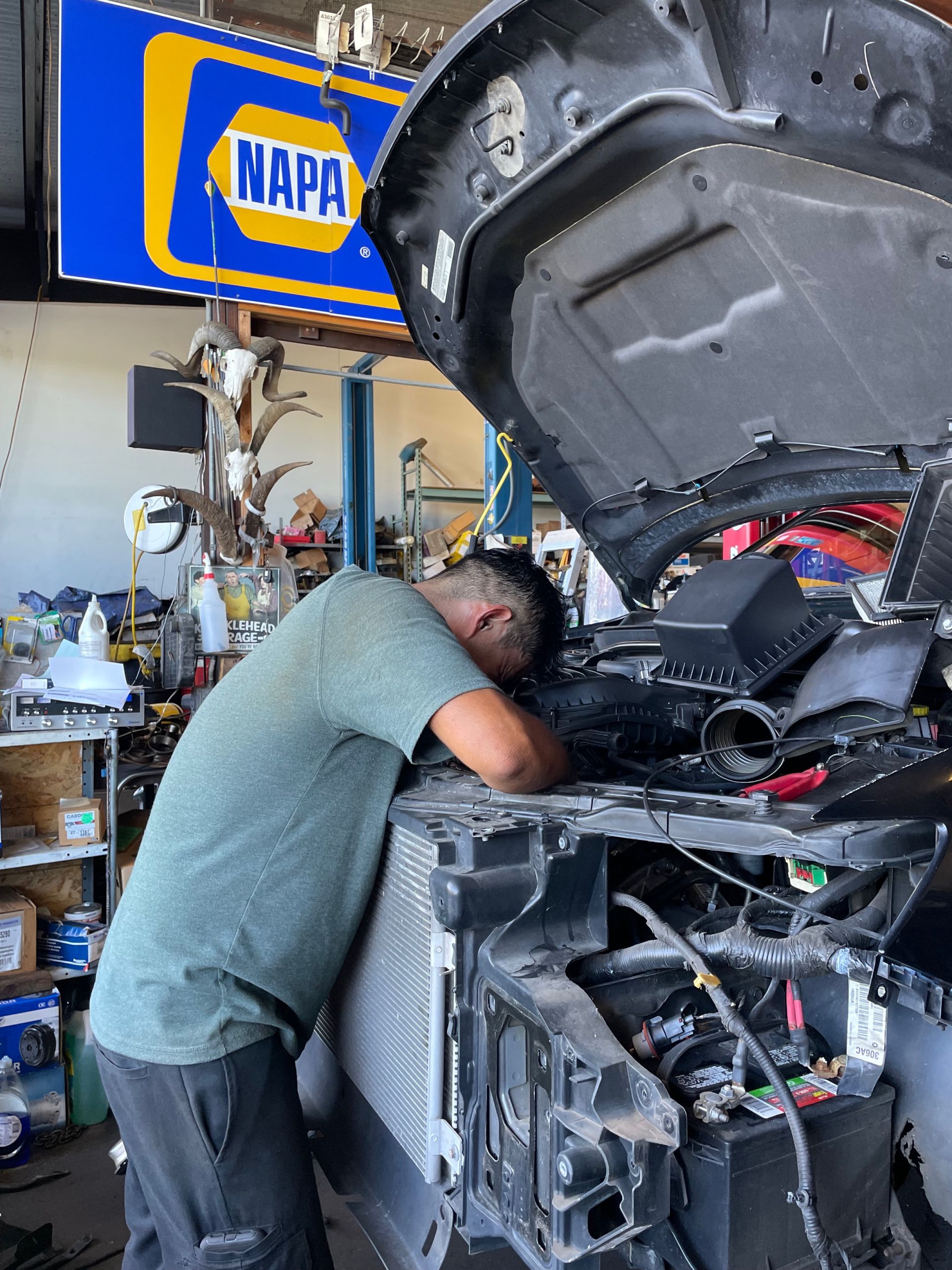 Mechanic working under the hood of a car