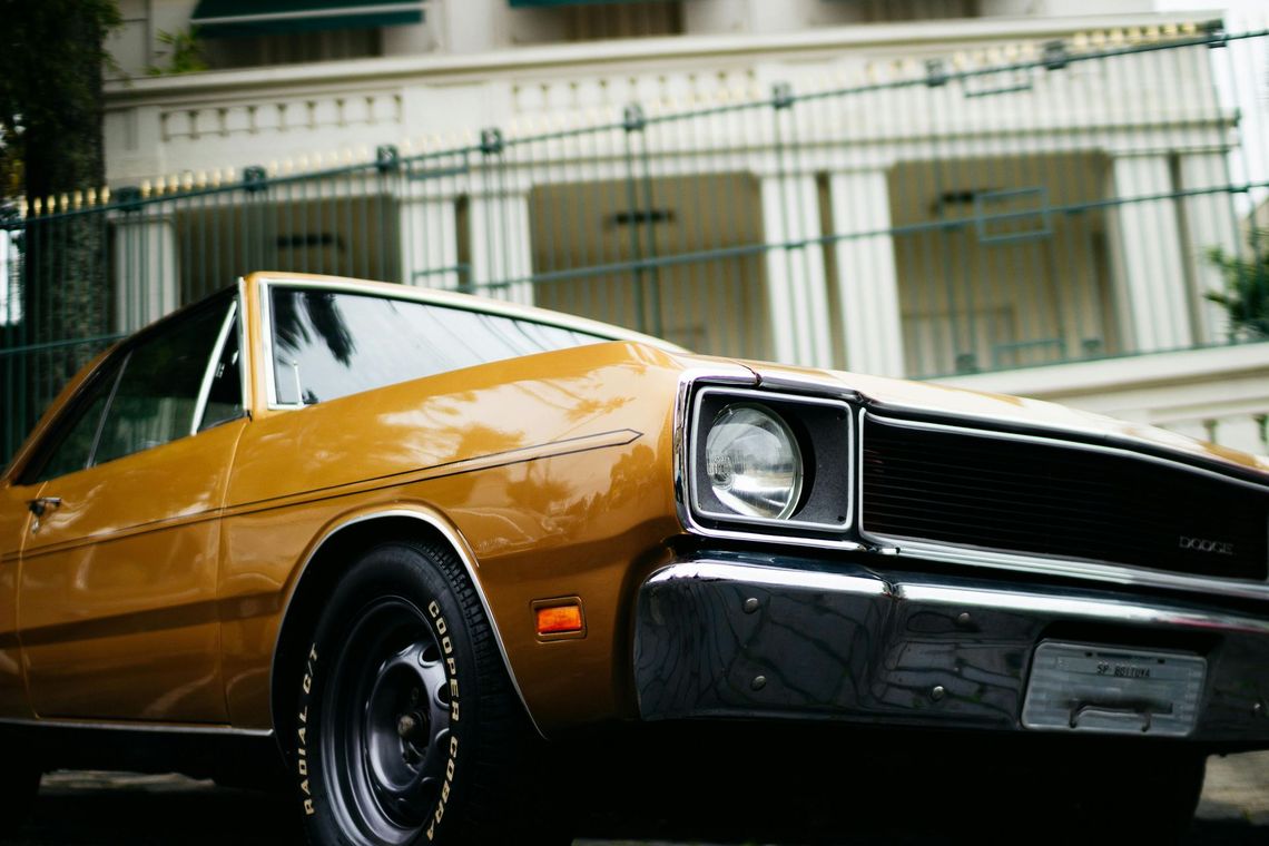 A yellow car is parked in front of a building