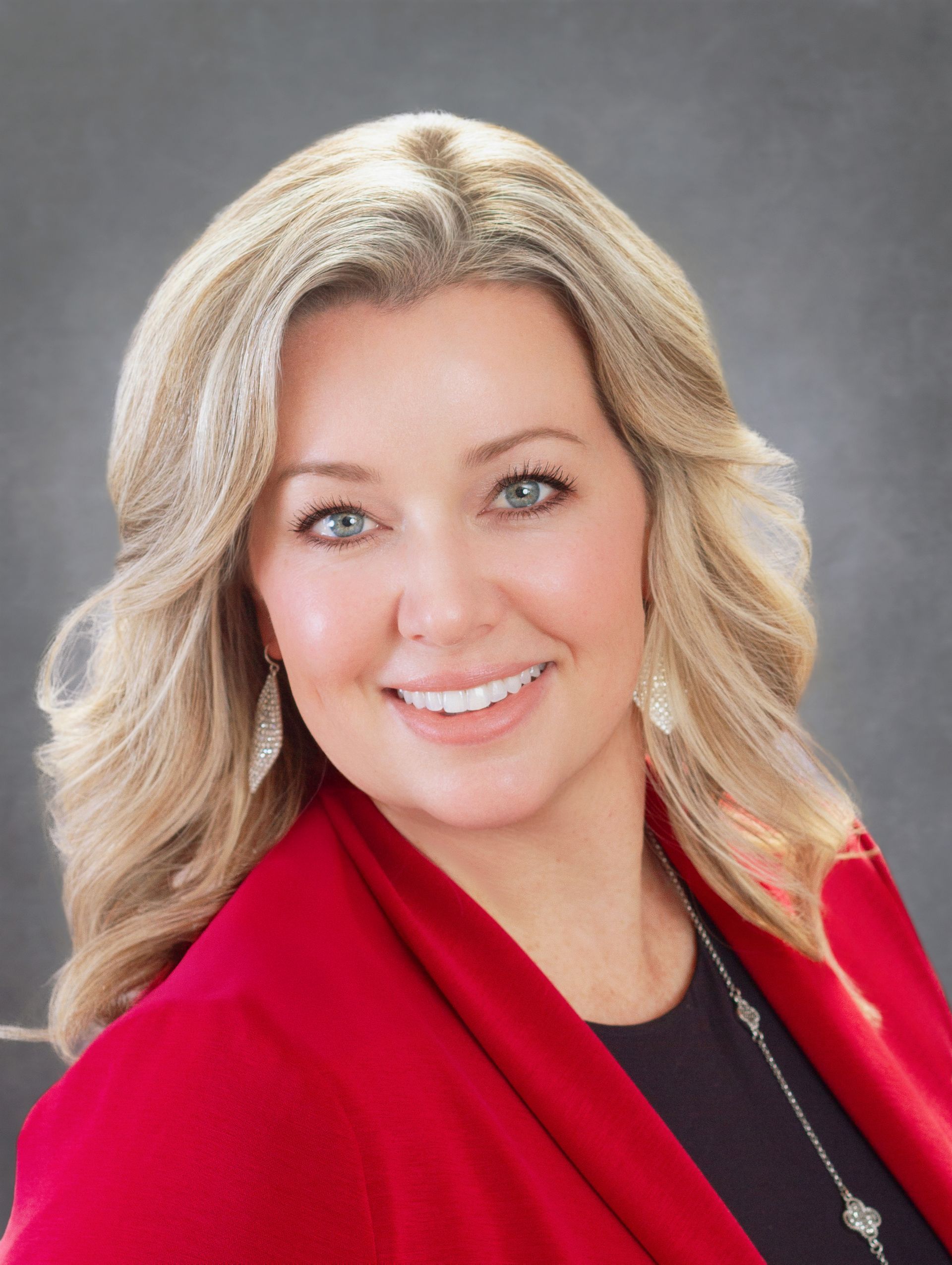 Portrait of Kristi Roske, APRN smiling wearing a pink blouse